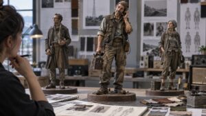 Designer comparing distinctive wardrobe and posture maquettes for an original radio repairer character